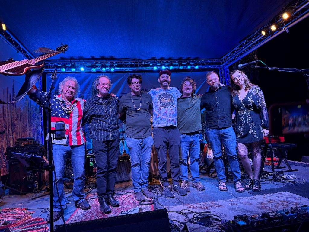 Tucson Bands and Concerts Guide (Mar 13–19, 2026) 6 Gift Horse band performing together on stage at Hotel Congress Plaza during a Tucson live music event, featuring members of the psychedelic rock and roots band under blue stage lights.