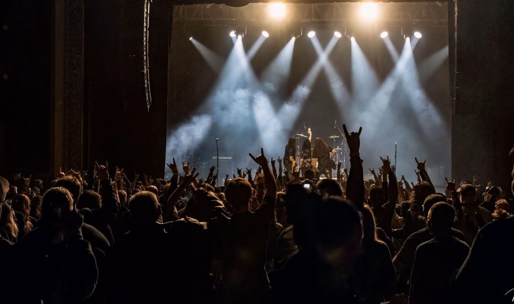 Tucson Band Spotlight: Znora 8 Znora 500th show Tucson live concert crowd at Rialto Theatre with fans cheering and hands raised