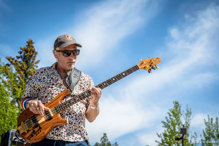 Mark Ryan of Legion of Mario playing bass guitar during an outdoor live performance in Tucson, Arizona. Photo courtesy of Chris Bachler.