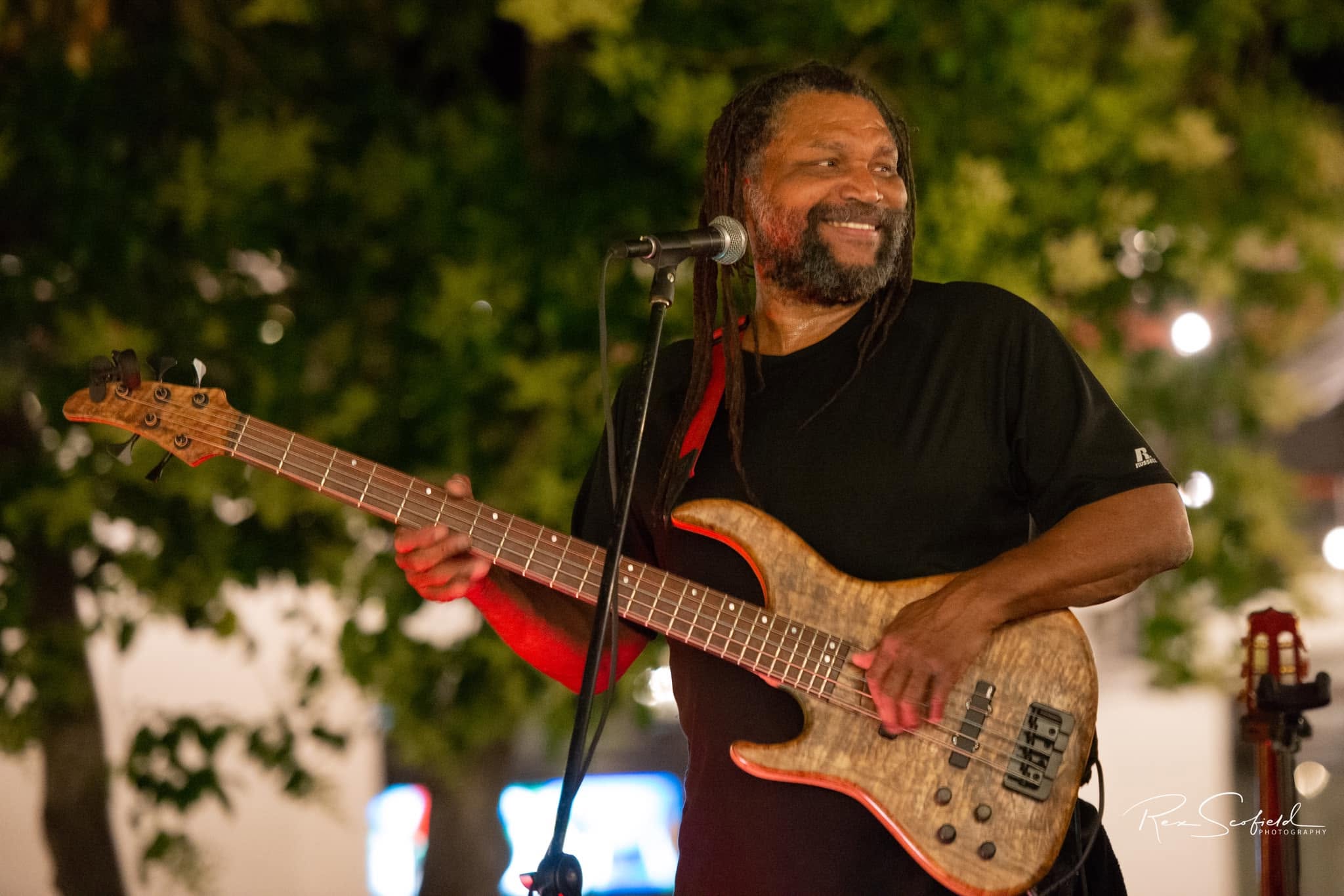 Amochip Dabney playing bass and singing live in Tucson. Photo by Rex Scofield.